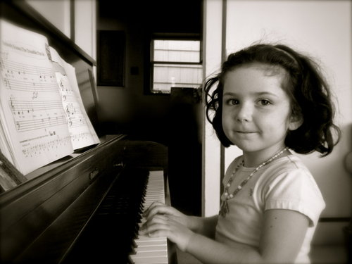 Joy's student Ellie pratices the piano