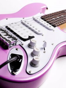 Close up of a pink electric guitar