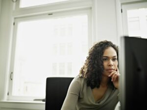 Determined woman sitting in front of a computer