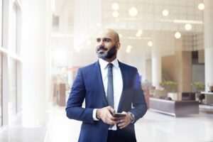 Bald businessman standing confidently in an office