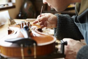 Man repairing a violin