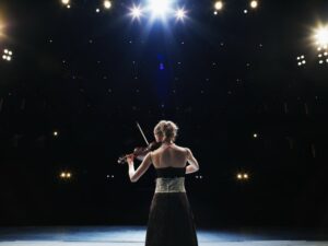 Woman playing violin on stage