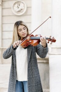 Young woman standing playing the violin