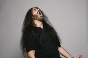Man with long hair singing