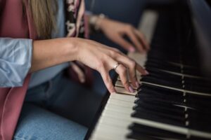 Closeup of a womans hands playing the piano
