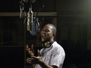 Young man singing in a recording studio 
