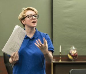 Teen girl practicing acting holding a script