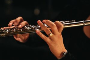 Close up of a woman's hands holding a flute