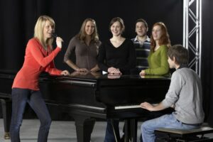 Choir group singing accompanied by piano