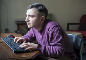 Man with bad posture staring at his computer