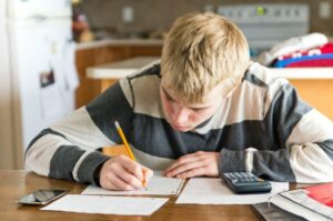 Teen boy doing his math homework