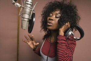 Female artist singing in a recording studio