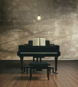 Black piano in an empty room