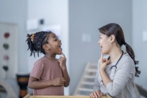 Little girl and speech therapist