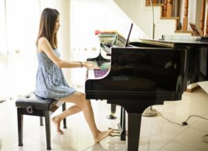 Teen girl practicing playing the piano