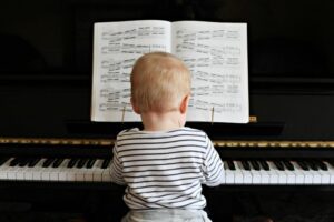 Baby sitting at piano