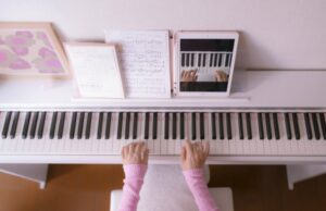 Close up of a girl taking remote piano lessons
