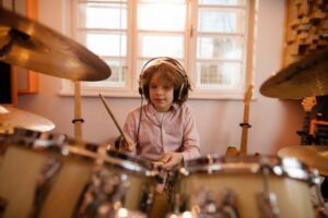 Little boy practicing playing the drums