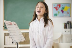 Little girl singing at a singing lesson