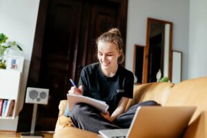 Teen girl studying in her living room