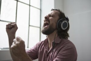 Man wearing headphones singing out loud