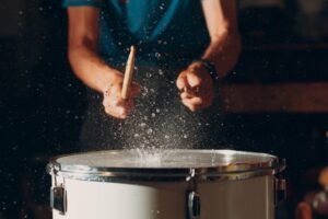 Close view of a man playing the drums
