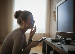 Young woman sitting in front of the tv