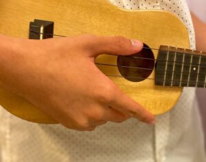 Closeup of man holding ukulele