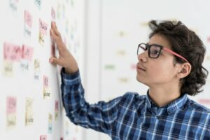 Teen boy studying Korean words on a wall