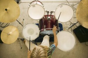 Top view of a little boy playing the drums