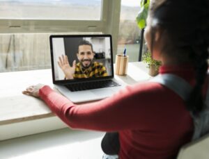 Young woman having a video call with a man