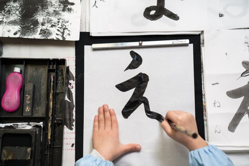 Close up of a child practicing writing Kanji