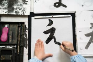 Closeup of a child practicing Japanese calligraphy