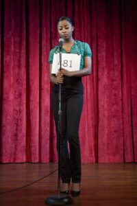 Woman standing nervously on stage for audition