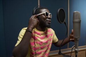 Male singer recording music in a studio