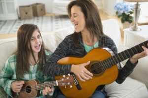 Mother and daughter playing ukulele together
