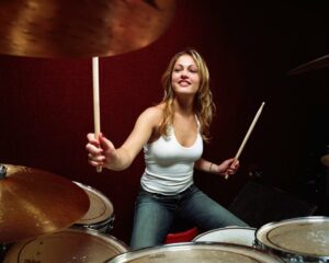 Blonde woman playing the drums
