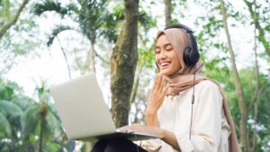 Woman in a hijab talking in sign language on a computer call