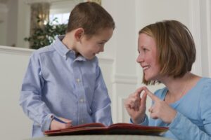 Mother teaching her son sign language