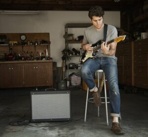 Man playing guitar in his garage
