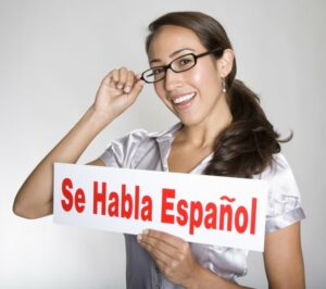 Young woman holding up a sign in Spanish