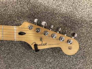 Another example of a Fender guitar with locking tuners to secure its guitar strings.