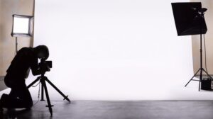 Back view of a man setting up equipment in a photography studio