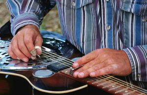 a man playing the slide guitar