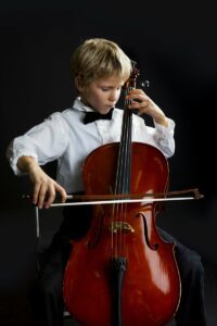Little boy playing the cello