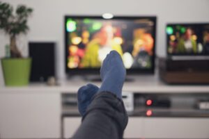 Man's socks in front of the tv he is watching