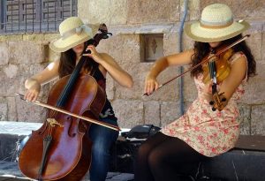 a woman plays a small cello