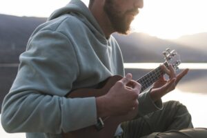 Bearded man strumming ukulele