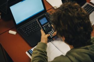 Boy using calculator while doing online homework
