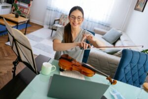Female instructor teaching virtual violin class